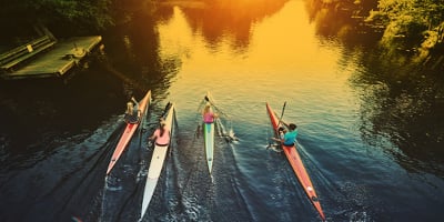 Early morning shot of a river with rowers.